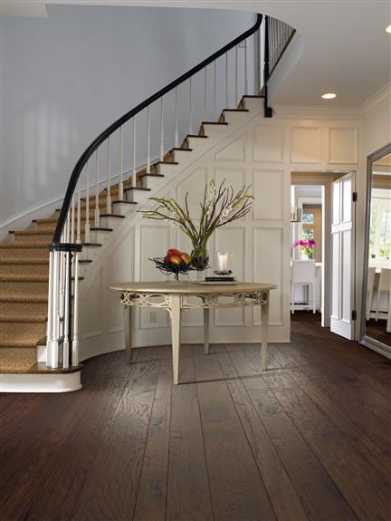 dark hardwood flooring with white walls and light hardwood stairs