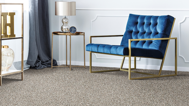 plush carpets in a modern living room with a blue velvet chair