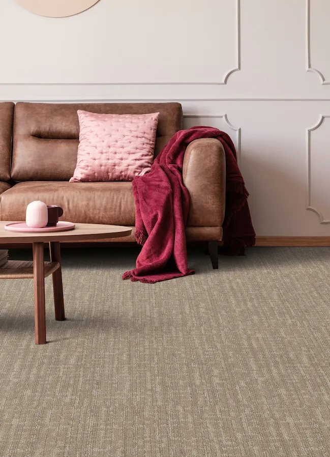 Brown textured carpet in a living room with pink accents
