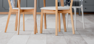 Person sitting on white area rug in living room